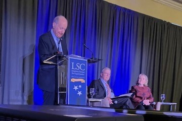 LSC's John Levi on stage with Former Secretary of State Hillary Clinton