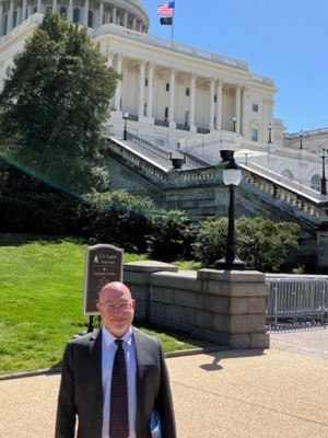 Sam Abel-Palmer standing in front of US Capitol